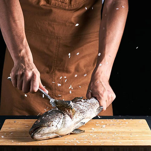 A man cooking a fish